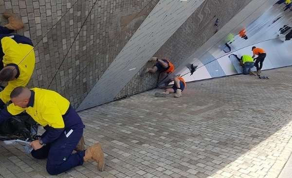 Workers building the Welcome wall